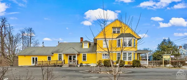 a living room with lots of furniture and a kitchen view