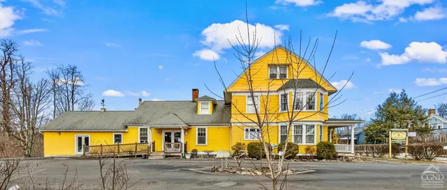 a living room with lots of furniture and a kitchen view