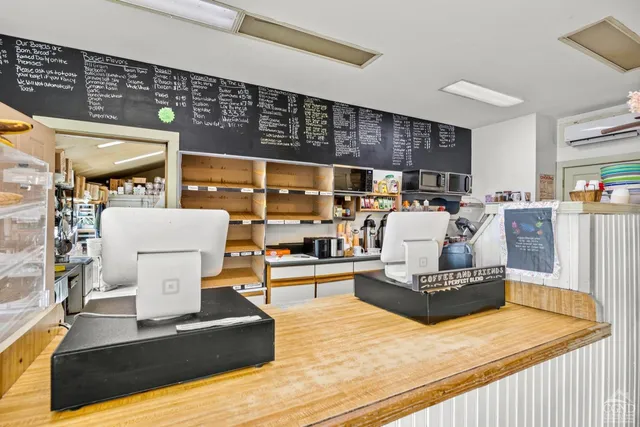 a picture of a living room with furniture and a window