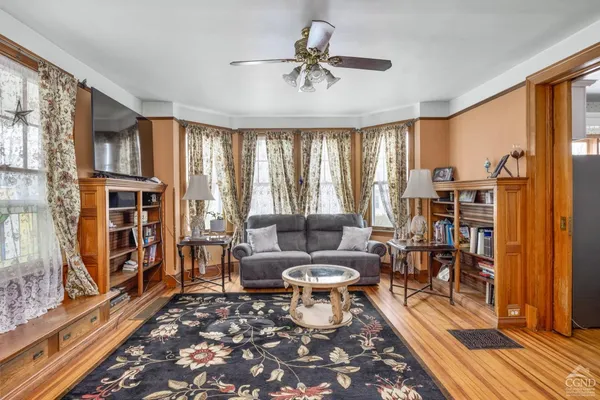 a living room with furniture and a book shelf