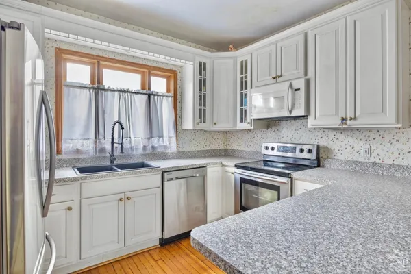 a view of a dining room with furniture wooden floor and a chandelier