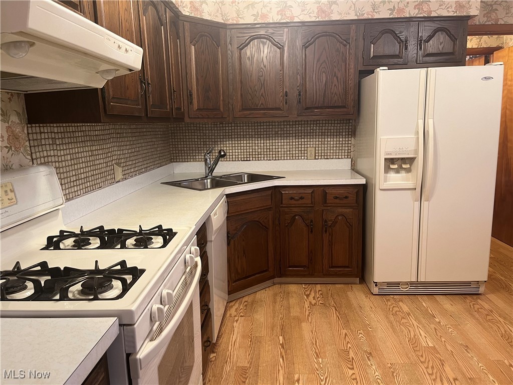 9152 Fosdick Road Cleveland, OH 44125 - Photo 8 of 45 Gas Stove with under cabinet range hood, and side-by-side refrigerator.