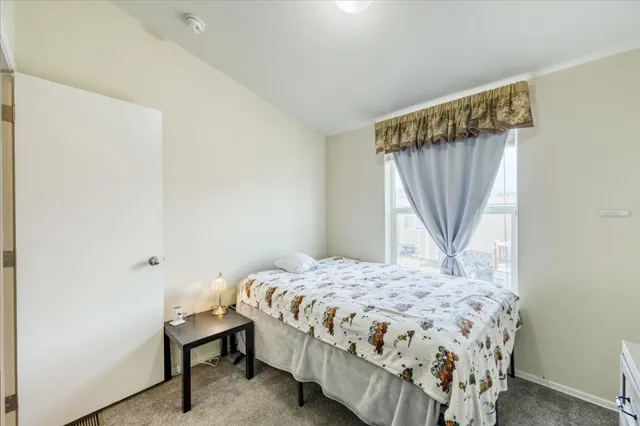 a bedroom with a bed and a window