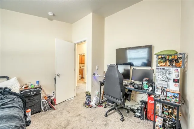 a view of a workspace with furniture and a window