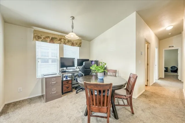 a dining room with furniture a chandelier and window