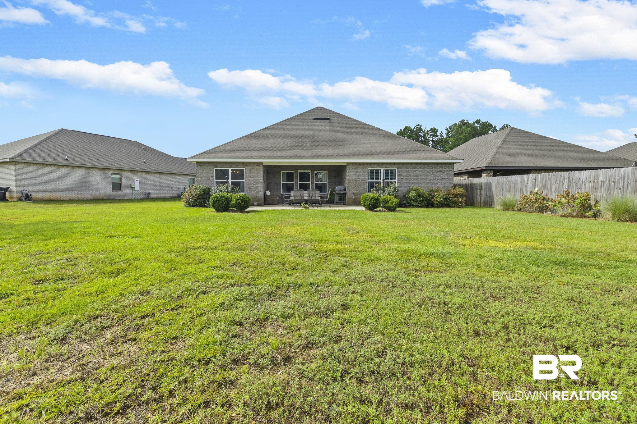 31663 Kestrel Loop Daphne, AL 36527 - Photo 51 of 86 Rear view of property with a yard and a patio area
