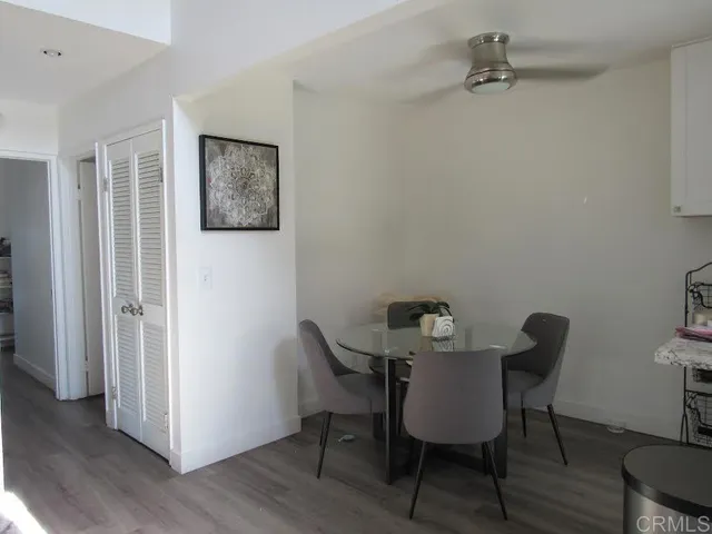 a view of a room with furniture and wooden floor
