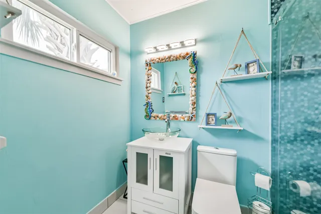 a bathroom with a toilet sink and mirror