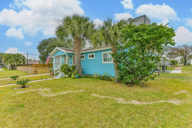 a view of a house with pool and a yard