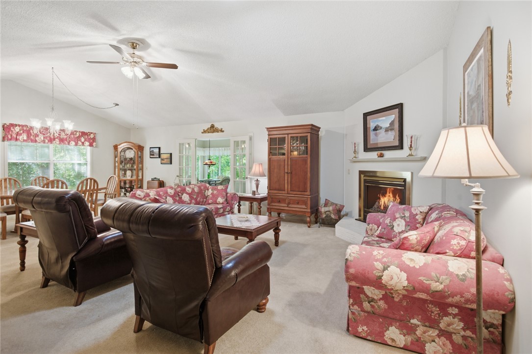 6 Tradewinds Way Salem, SC 29676 - Photo 3 of 50 This inviting living area boasts a cozy fireplace and a ceiling fan, perfect for year-round comfort.