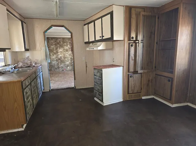 a kitchen with refrigerator a washer and dryer