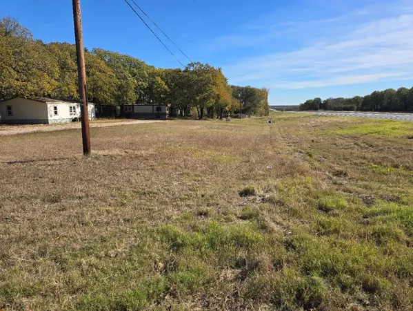 a view of a field with an ocean view