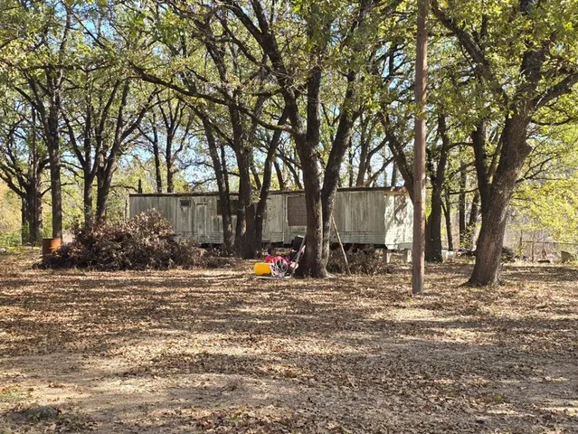 a view of a outdoor space with trees and backyard
