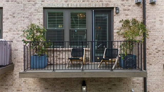 a living room with furniture a chandelier and wooden floor