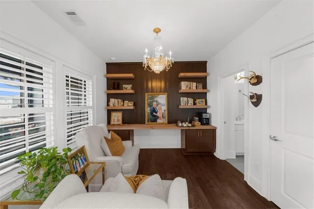a balcony with furniture and a large window