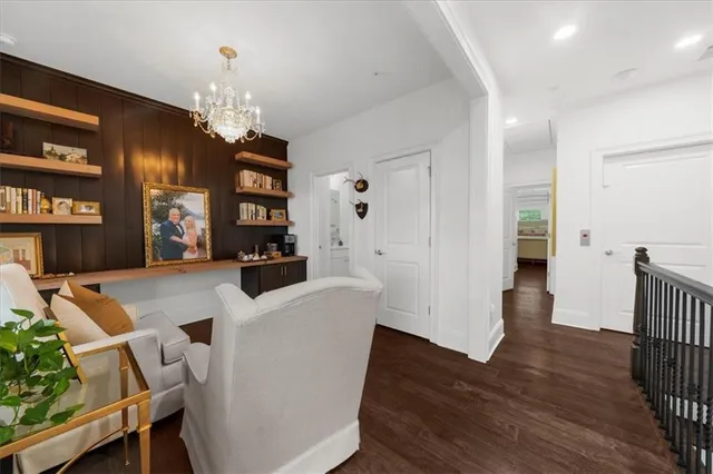 a living room with furniture a potted plant and a fireplace