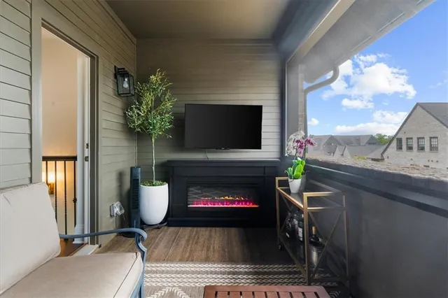 a bedroom with a bed a couch and a chandelier