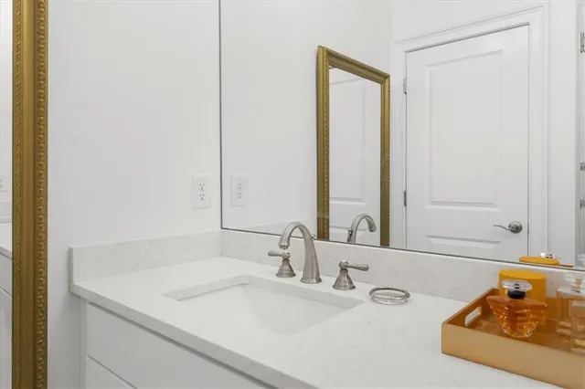 a bedroom with a bed and a night stand