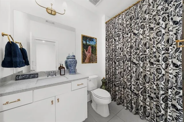 a living room with furniture a flat screen tv and kitchen view