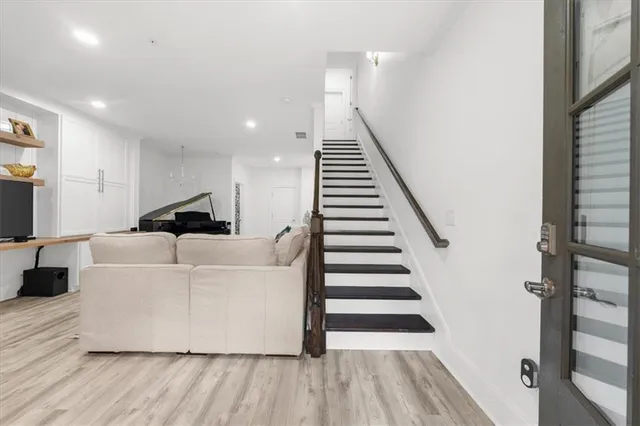 a living room with furniture and wooden floor