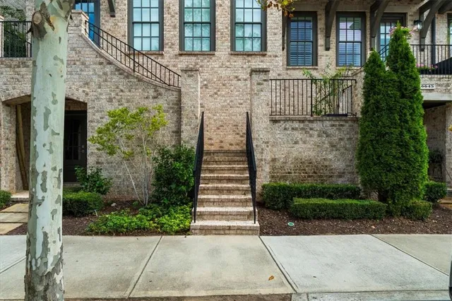 a front view of a house with a yard and garden