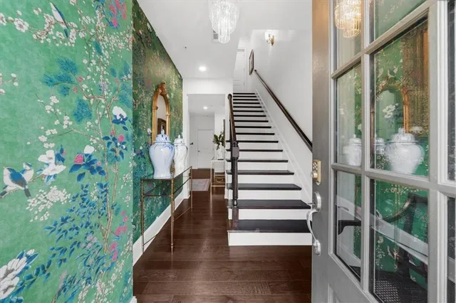 a view of a hallway with workspace and living room