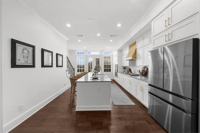 a kitchen with stainless steel appliances granite countertop a stove top oven a sink a counter space and cabinets