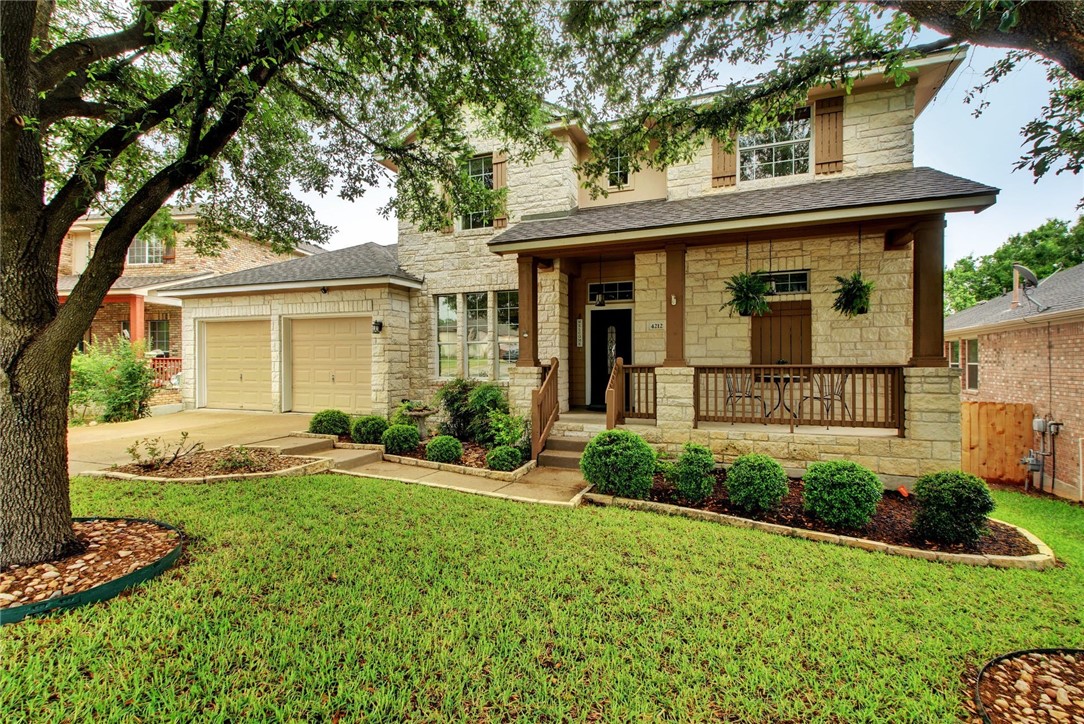 a front view of a house with a yard and porch
