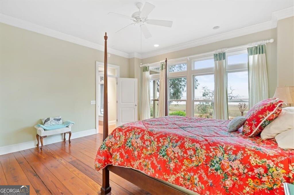 1045 River Club Road Northeast Townsend, GA 31331 - Photo 23 of 85 a bedroom with a bed and a window