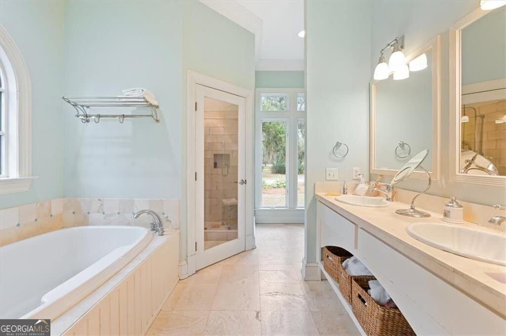 1045 River Club Road Northeast Townsend, GA 31331 - Photo 26 of 85 a spacious bathroom with a tub sink and mirror