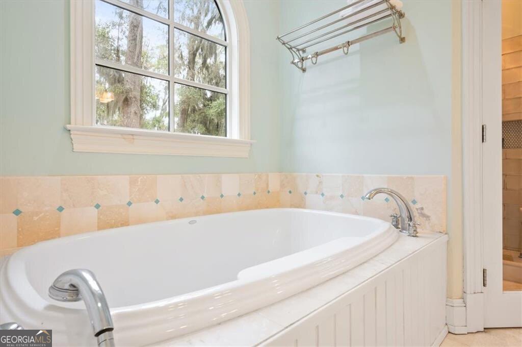 1045 River Club Road Northeast Townsend, GA 31331 - Photo 28 of 85 a bathroom with a tub and a window