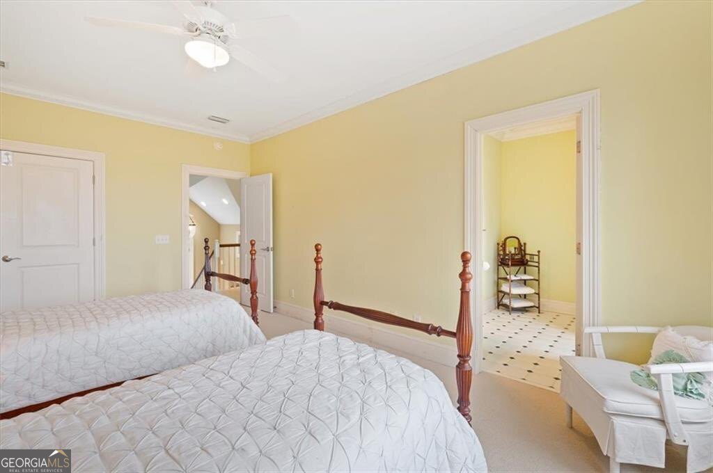 1045 River Club Road Northeast Townsend, GA 31331 - Photo 44 of 85 a bedroom with a bed and a chandelier