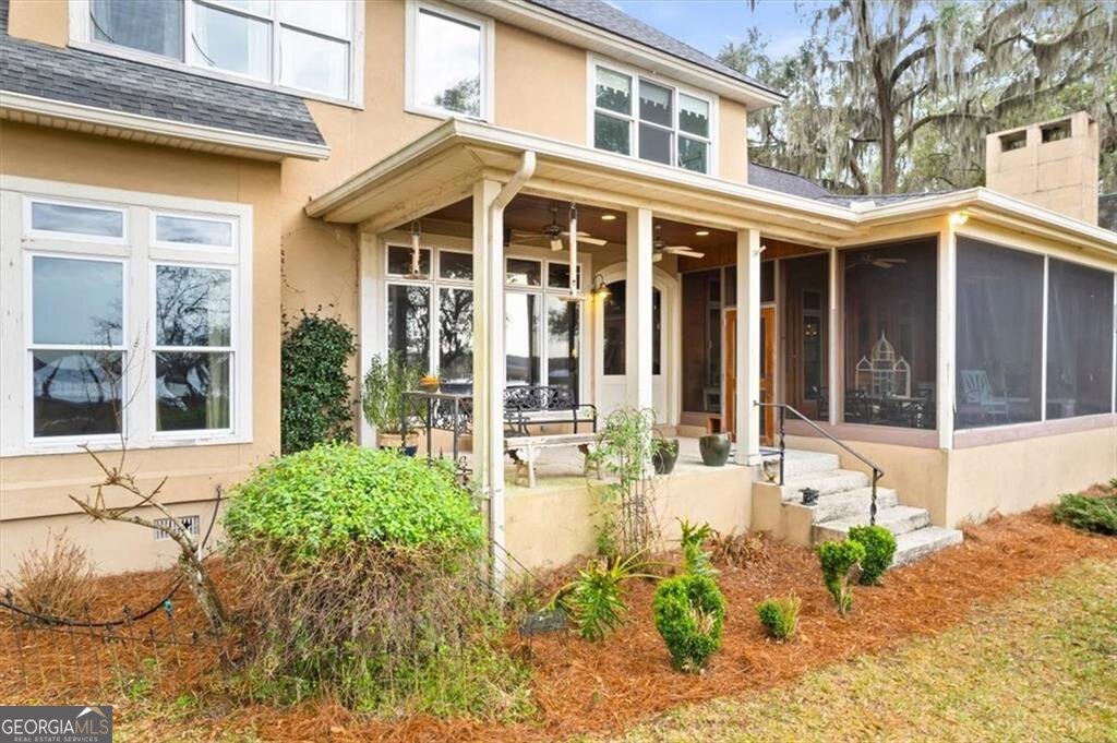 1045 River Club Road Northeast Townsend, GA 31331 - Photo 51 of 85 a front view of a house with a yard outdoor seating and barbeque oven
