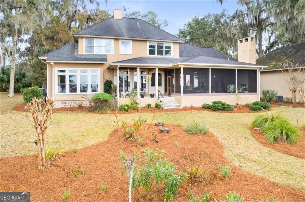1045 River Club Road Northeast Townsend, GA 31331 - Photo 58 of 85 a front view of a house with a yard and potted plants