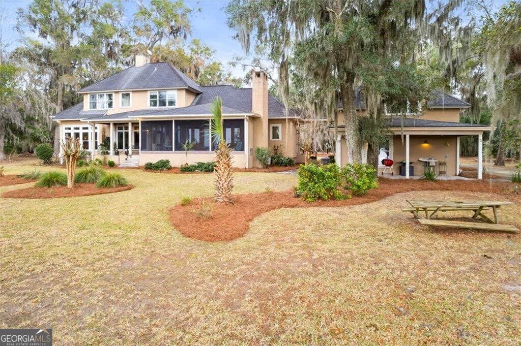 1045 River Club Road Northeast Townsend, GA 31331 - Photo 59 of 85 a front view of a house with yard and green space