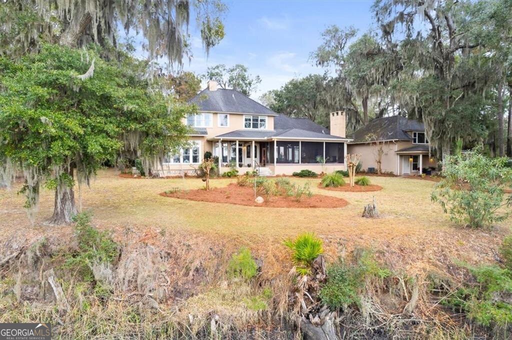 1045 River Club Road Northeast Townsend, GA 31331 - Photo 60 of 85 a front view of a house with a yard and large trees