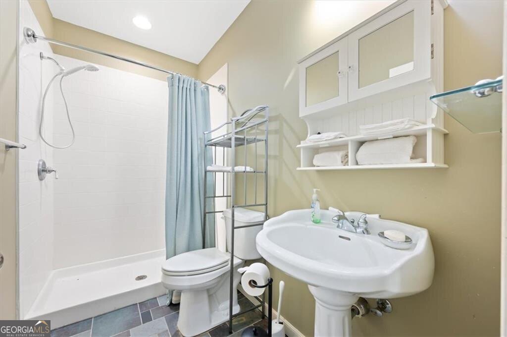 1045 River Club Road Northeast Townsend, GA 31331 - Photo 66 of 85 a bathroom with a sink a toilet and shower