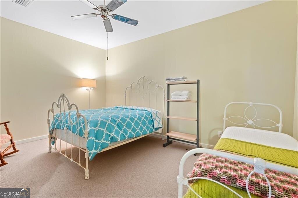 1045 River Club Road Northeast Townsend, GA 31331 - Photo 67 of 85 a bedroom with a bed and a chandelier
