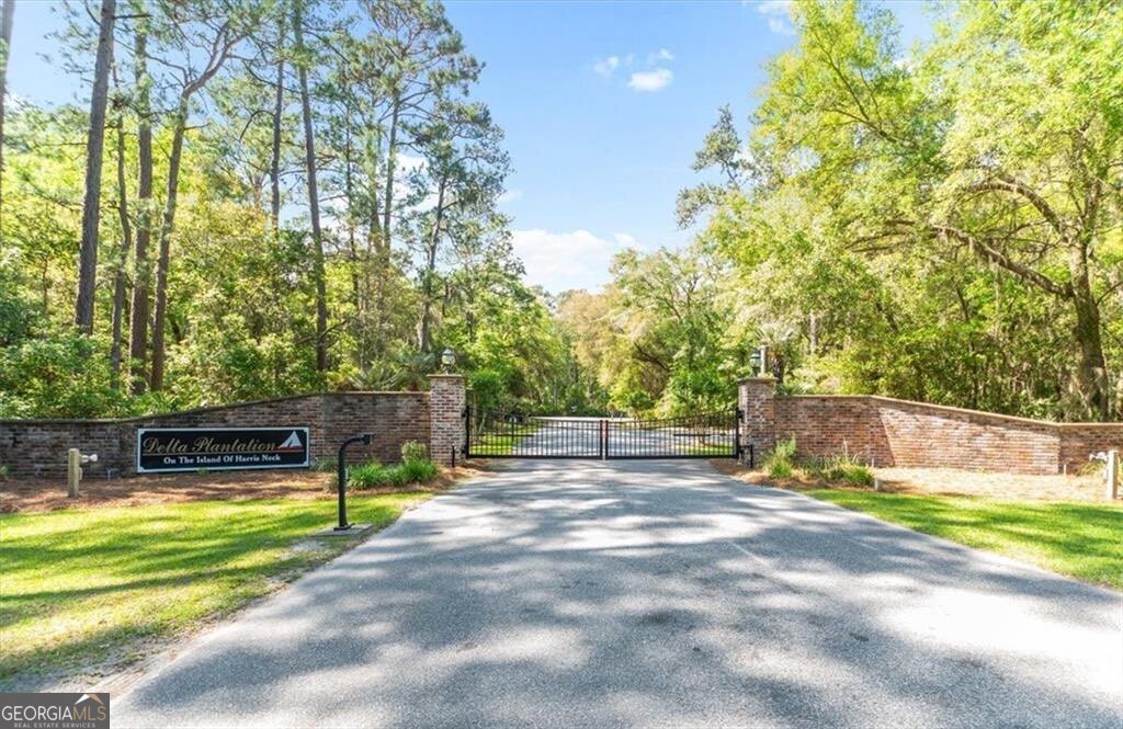 1045 River Club Road Northeast Townsend, GA 31331 - Photo 72 of 85 a view of a swimming pool with a yard and large trees