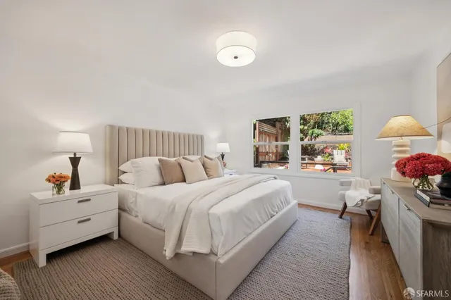 a bedroom with a bed and a large window