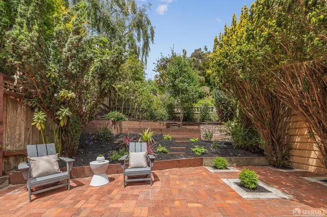 a view of a patio with a table and chairs under an umbrella