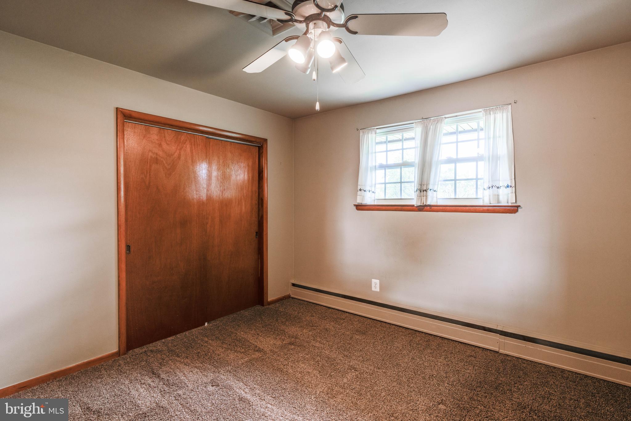 2500 Crestview Drive Fallston, MD 21047 - Photo 20 of 30 an empty room with a chandelier fan and windows
