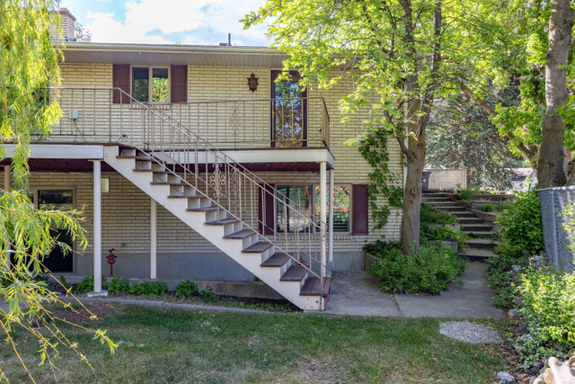 1365 Sumac Drive Logan, UT 84321 - Photo 63 of 66 Rear exterior featuring light-colored brick siding and a white metal railing system