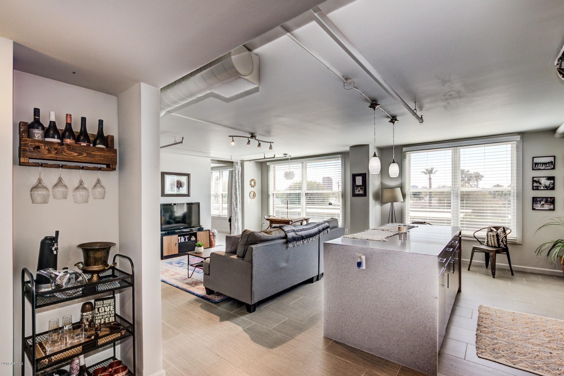 535 West Thomas Road, Unit 208 Phoenix, AZ 85013 - Photo 2 of 22 a living room with furniture and a large window