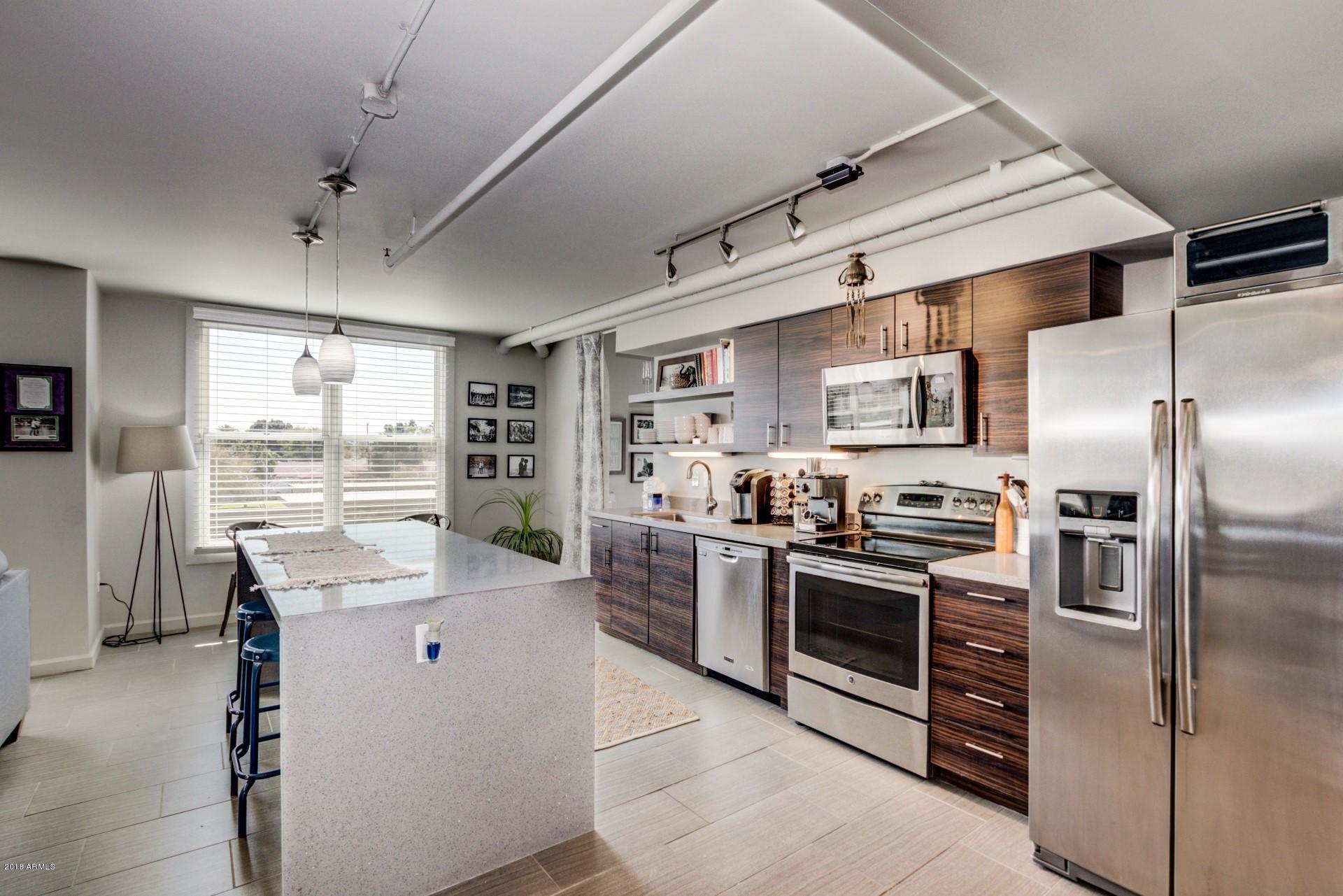 535 West Thomas Road, Unit 208 Phoenix, AZ 85013 - Photo 3 of 22 a kitchen with stainless steel appliances a stove sink and refrigerator