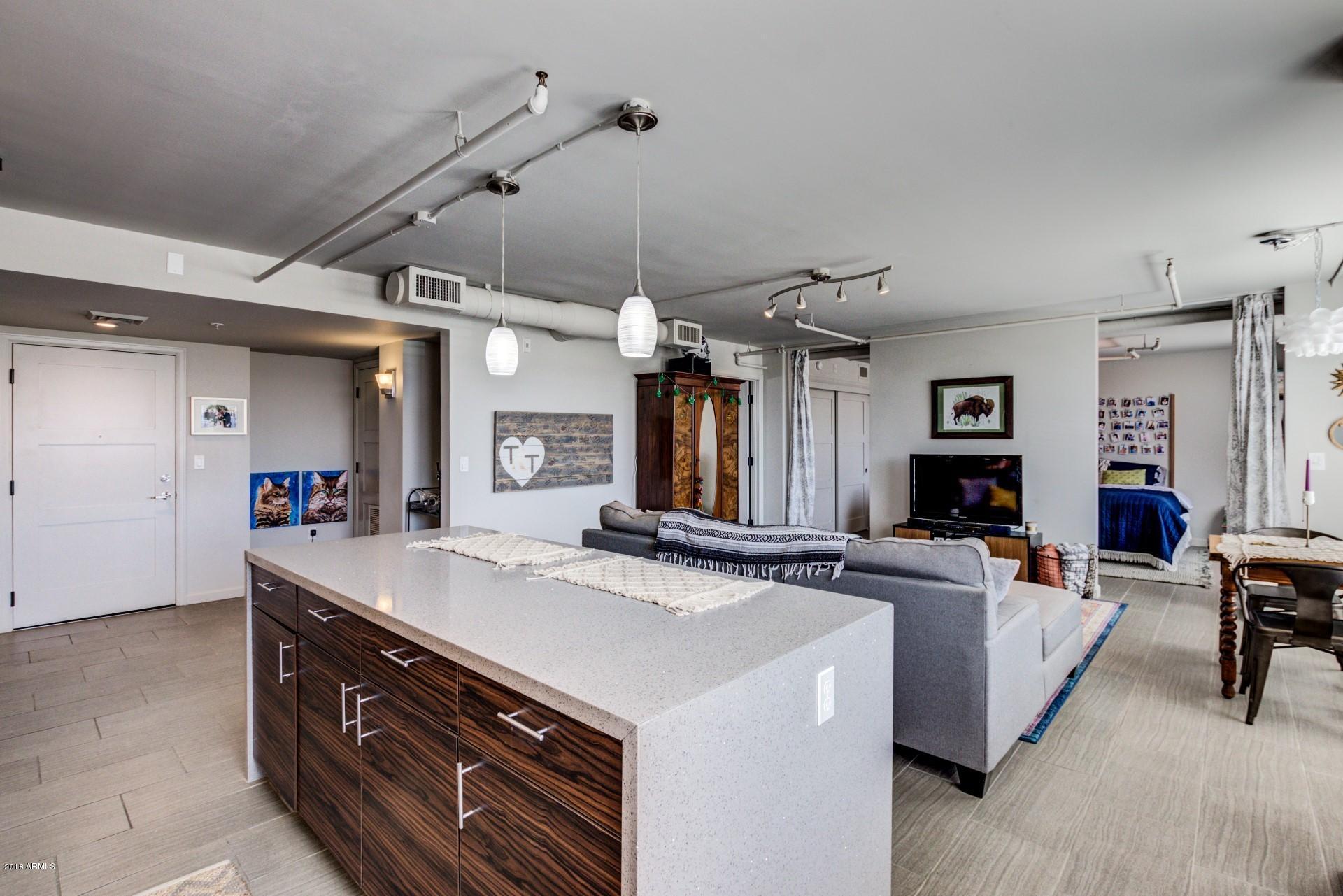 535 West Thomas Road, Unit 208 Phoenix, AZ 85013 - Photo 5 of 22 a view of a kitchen counter top space with furniture and a fireplace