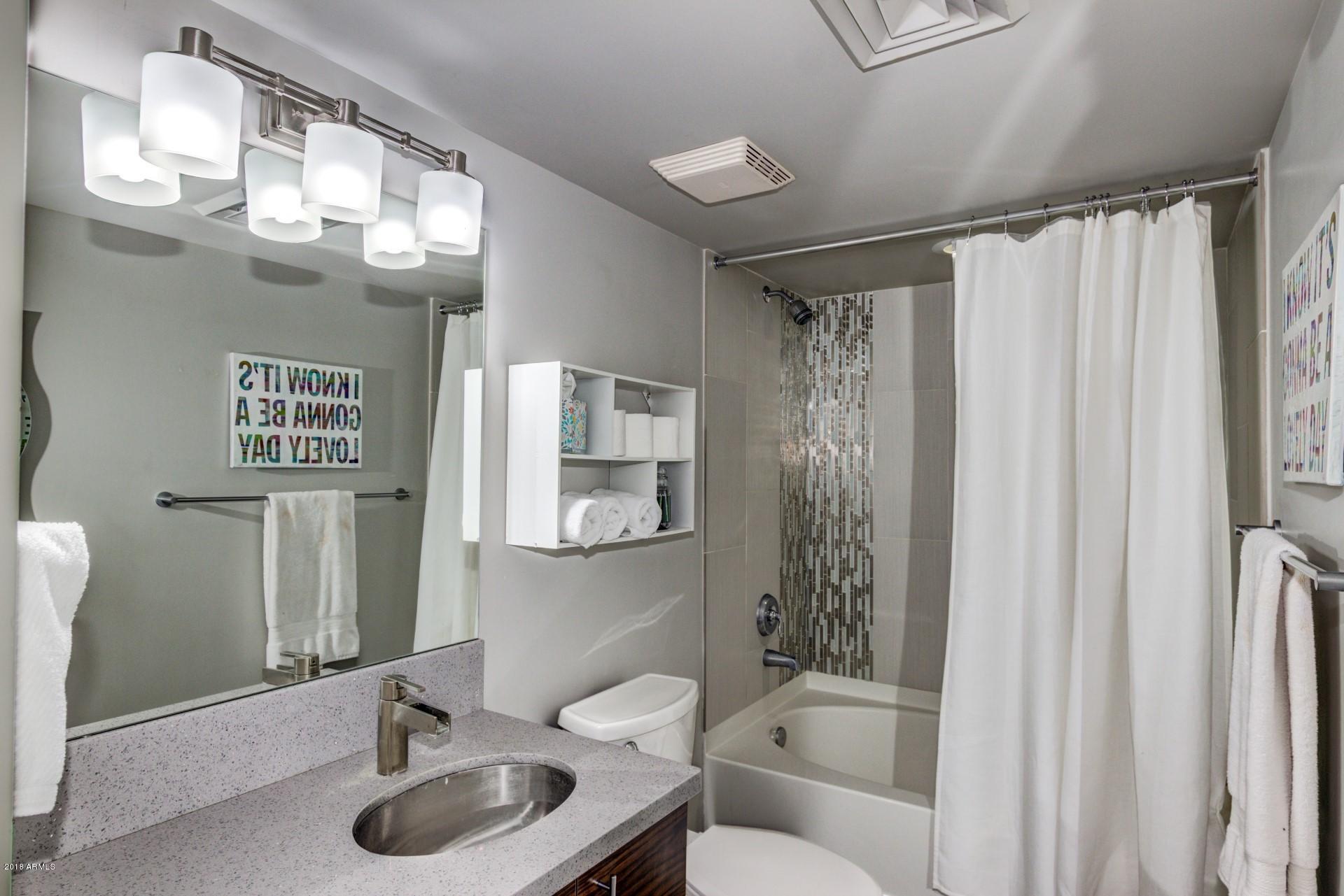 535 West Thomas Road, Unit 208 Phoenix, AZ 85013 - Photo 8 of 22 a bathroom with a sink a toilet and shower