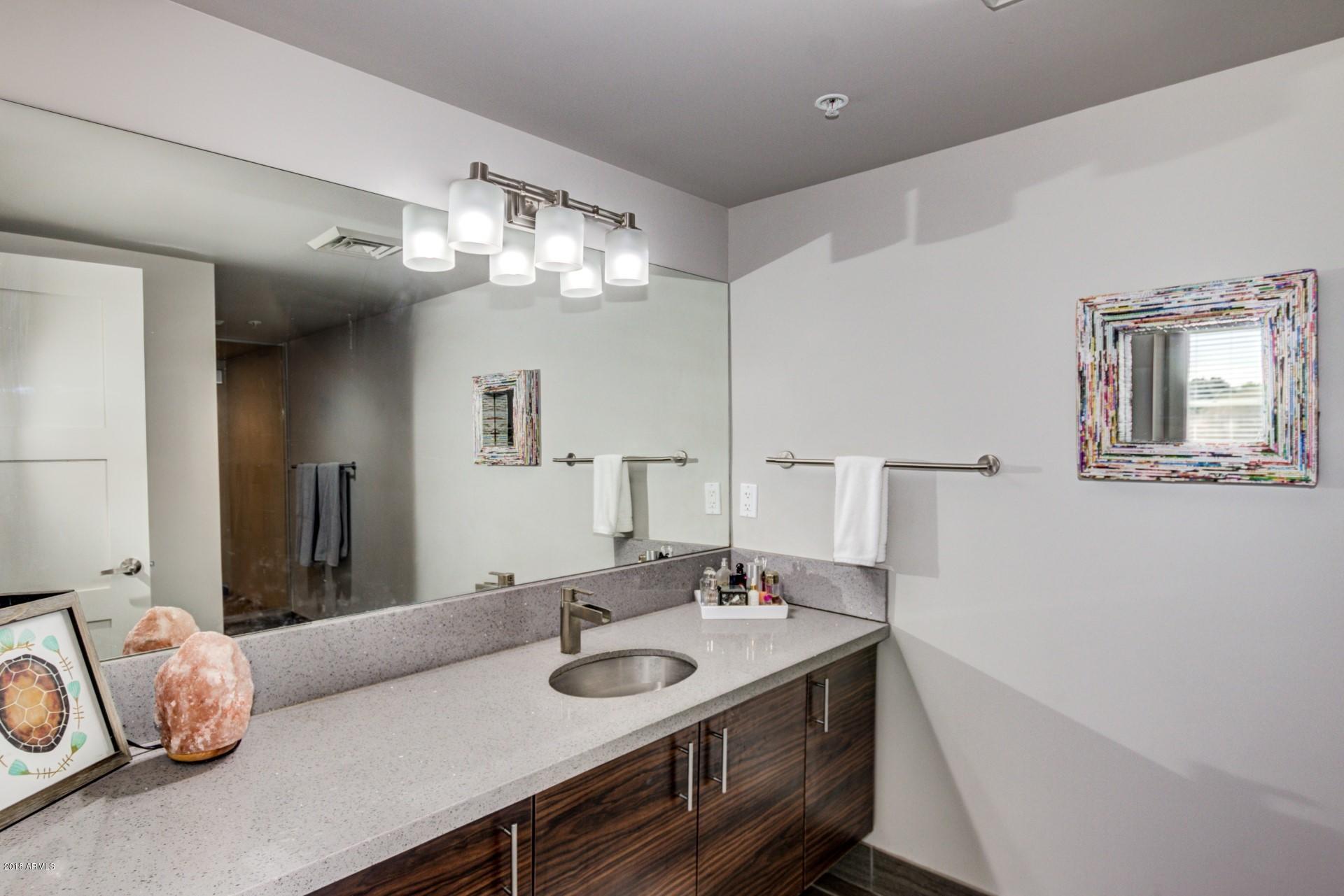 535 West Thomas Road, Unit 208 Phoenix, AZ 85013 - Photo 10 of 22 a bathroom with a sink and a mirror