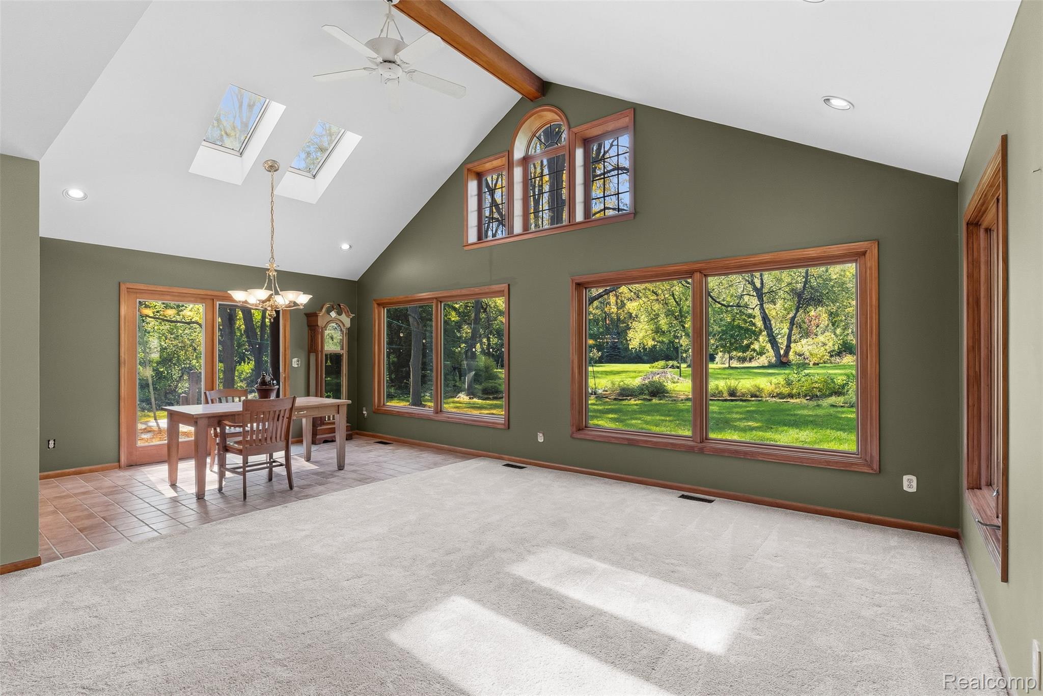 8135 Ranch Estates Road Clarkston, MI 48348 - Photo 15 of 53 Vaulted ceiling, exposed wood beam, skylights, wood-framed windows, and tile flooring