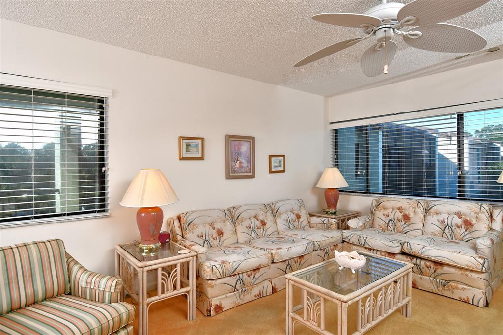2001 Little Pine Circle, Unit 11B Punta Gorda, FL 33955 - Photo 12 of 45 a living room with furniture and a large window